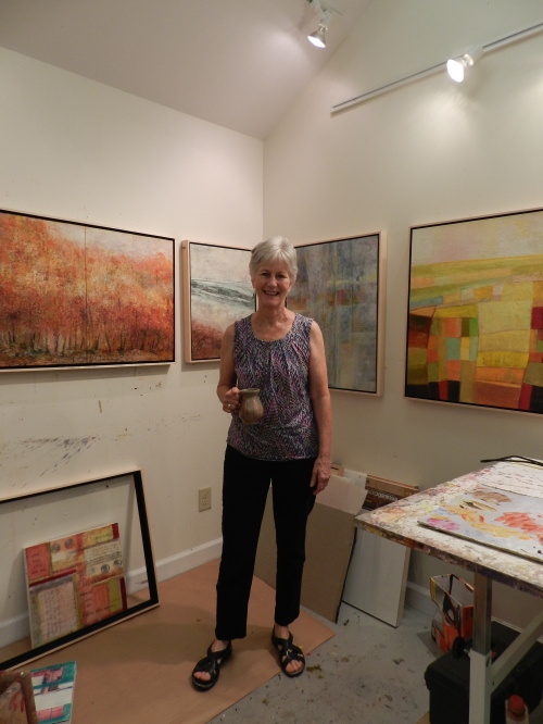 Mixed Media Artist, Peg Bachenheimer in her home studio in Carrboro, NC. The paintings in the background will be exhibited at Frank Gallery beginning September 8th.